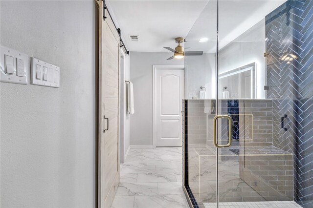 bathroom featuring marble finish floor, ceiling fan, a shower stall, and visible vents