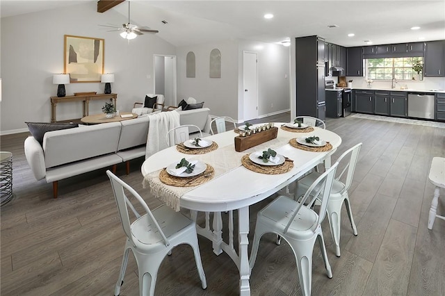 dining area with hardwood / wood-style floors, lofted ceiling with beams, ceiling fan, and sink