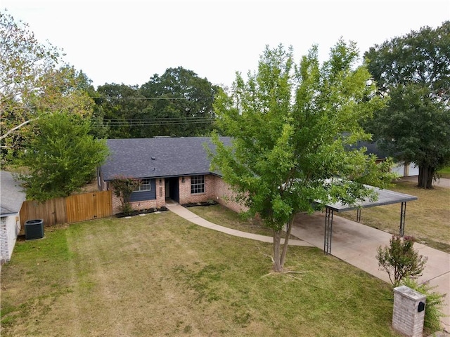 ranch-style home with a carport, cooling unit, and a front yard