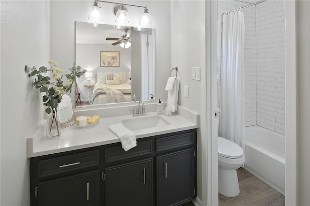 full bathroom featuring shower / bath combination with curtain, vanity, ceiling fan, wood-type flooring, and toilet