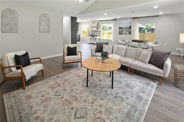 living room with hardwood / wood-style flooring and vaulted ceiling