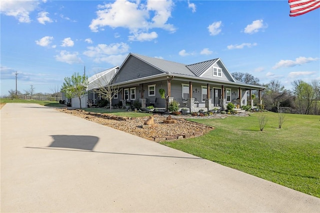 1858 Valley View Dr, Anderson, TX 77830 - country-style home with covered porch, concrete driveway, a front yard, and metal roof
