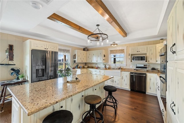 1858 Valley View Dr, Anderson, TX 77830 - kitchen featuring stainless steel appliances, a center island, dark wood-style flooring, a kitchen bar, and beamed ceiling