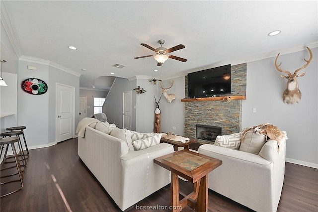 living room featuring a fireplace, ornamental molding, ceiling fan, and dark wood-type flooring