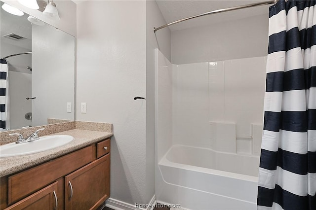 bathroom with shower / bath combo and vanity