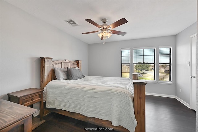 bedroom with ceiling fan and dark wood-type flooring