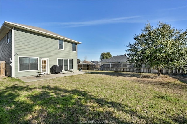 rear view of property with a patio area and a yard