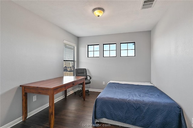 bedroom with dark hardwood / wood-style floors