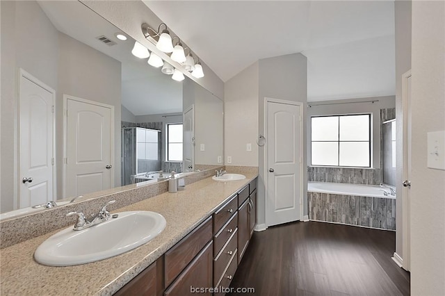 bathroom with plenty of natural light, vanity, wood-type flooring, and lofted ceiling