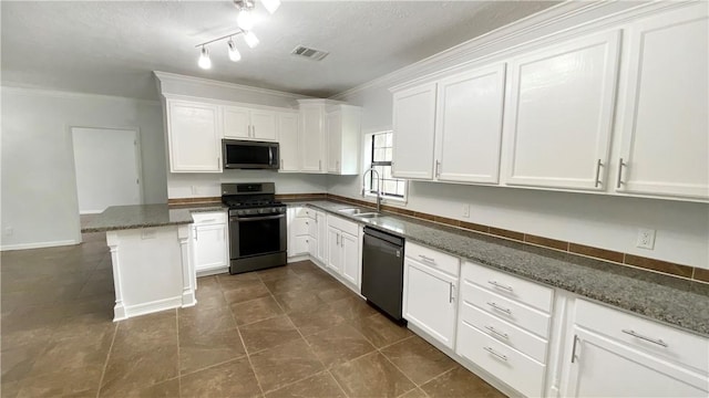 kitchen featuring white cabinets, dark stone countertops, sink, and stainless steel appliances