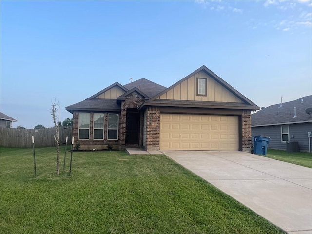 833 Mockingbird St, Navasota, TX 77868 - view of front of home featuring board and batten siding, central air condition unit, an attached garage, driveway, and brick siding