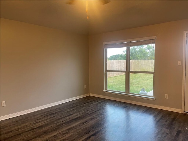833 Mockingbird St, Navasota, TX 77868 - empty room featuring baseboards, dark wood-type flooring, and a ceiling fan