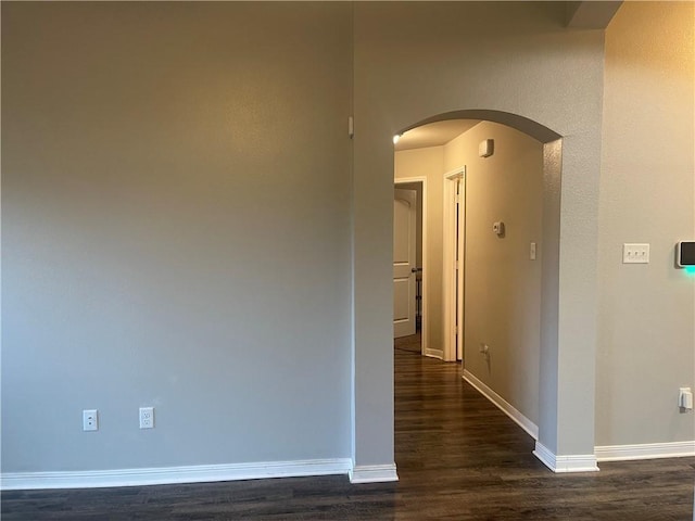 833 Mockingbird St, Navasota, TX 77868 - hall featuring dark wood-type flooring, arched walkways, and baseboards
