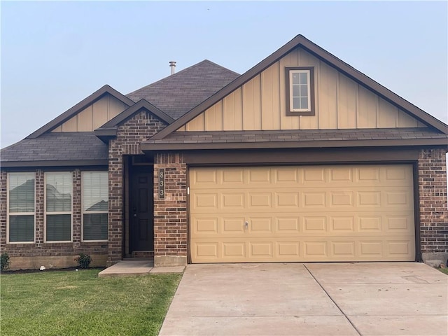 833 Mockingbird St, Navasota, TX 77868 - view of front of home featuring board and batten siding, driveway, a garage, and brick siding