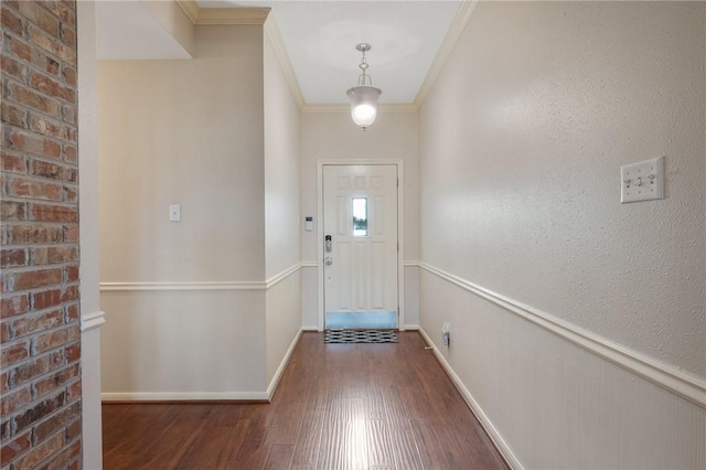 doorway with dark hardwood / wood-style flooring and crown molding