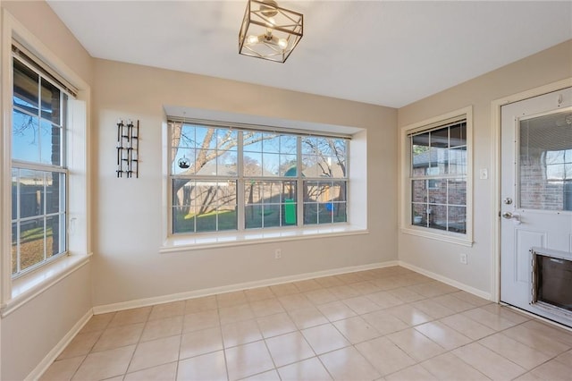 unfurnished dining area with plenty of natural light and light tile patterned flooring