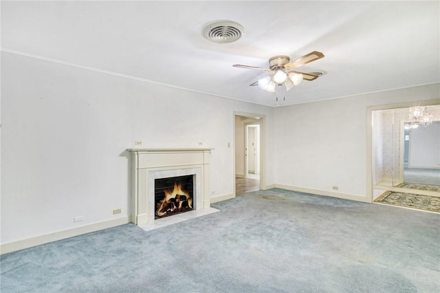 unfurnished living room featuring a high end fireplace, carpet floors, ceiling fan, and crown molding