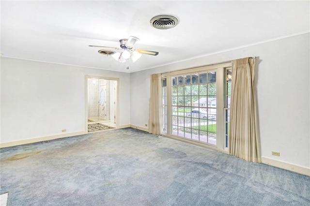 carpeted spare room featuring ceiling fan and ornamental molding