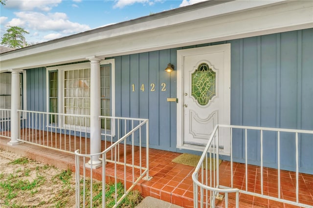 view of exterior entry with a porch