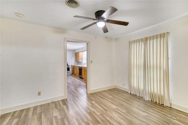 spare room featuring wine cooler, light hardwood / wood-style flooring, ceiling fan, and ornamental molding