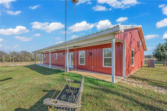 back of property with a patio area and a lawn