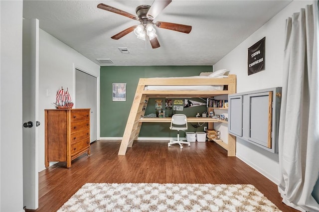 bedroom featuring visible vents, ceiling fan, and wood finished floors