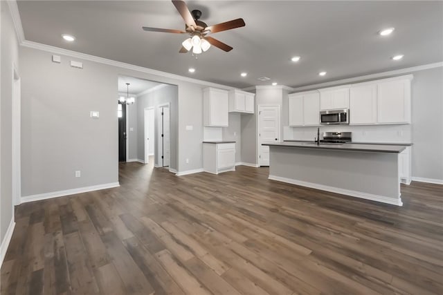 6434 Raleigh Loop, College Station, TX 77845 - kitchen featuring stainless steel appliances, ornamental molding, dark countertops, ceiling fan, and a chandelier