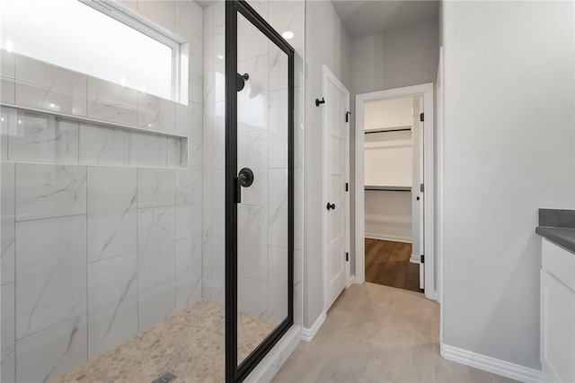 6434 Raleigh Loop, College Station, TX 77845 - bathroom with a stall shower, a walk in closet, vanity, and tile patterned floors