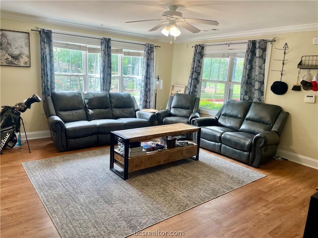 living room featuring hardwood / wood-style floors, ornamental molding, and a wealth of natural light