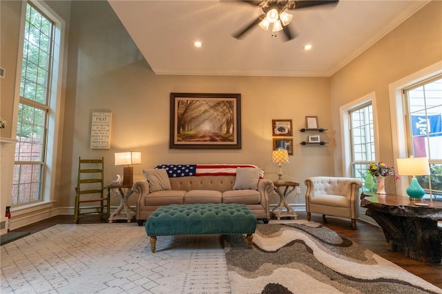 living room featuring crown molding, hardwood / wood-style floors, and ceiling fan