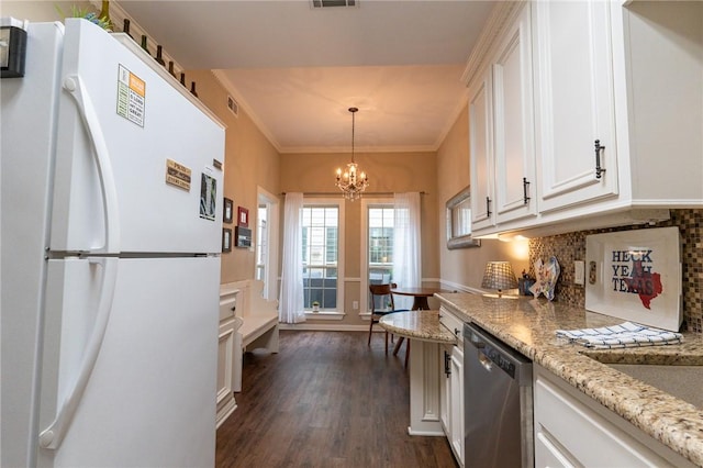 kitchen with dishwasher, white cabinets, ornamental molding, white fridge, and dark hardwood / wood-style flooring