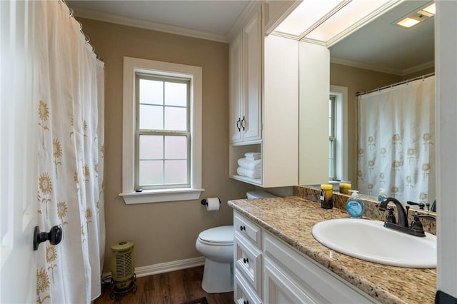 bathroom with toilet, vanity, ornamental molding, and hardwood / wood-style flooring