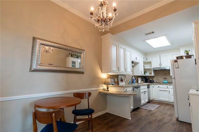 kitchen with a breakfast bar, backsplash, white cabinets, dark hardwood / wood-style floors, and ornamental molding