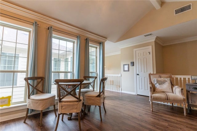 dining room with vaulted ceiling with beams, a wealth of natural light, dark hardwood / wood-style floors, and ornamental molding