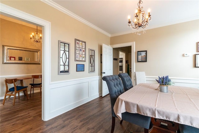 dining area with dark hardwood / wood-style floors, ornamental molding, and a notable chandelier