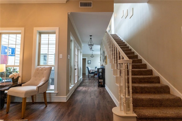 stairway featuring hardwood / wood-style floors and ornamental molding