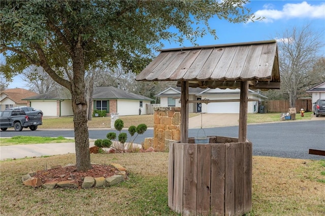 exterior space with a garage and a lawn