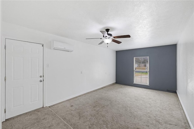 spare room with light carpet, ceiling fan, an AC wall unit, and a textured ceiling