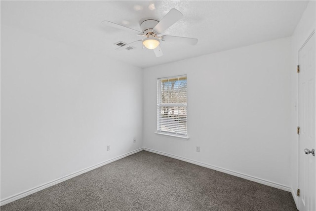 carpeted spare room featuring ceiling fan