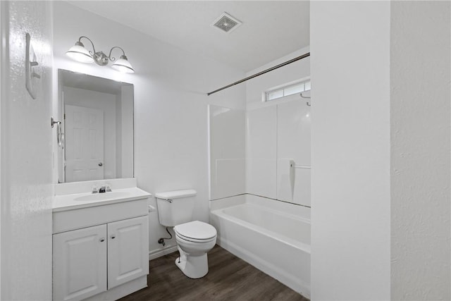 full bathroom with wood-type flooring, vanity, washtub / shower combination, and toilet