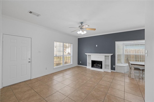 unfurnished living room featuring crown molding, light tile patterned floors, and ceiling fan