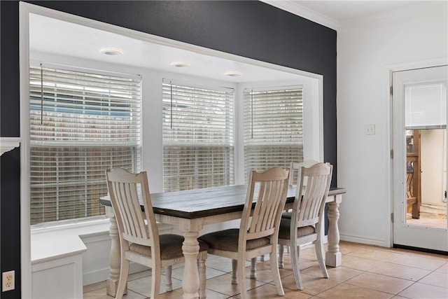 tiled dining space featuring ornamental molding