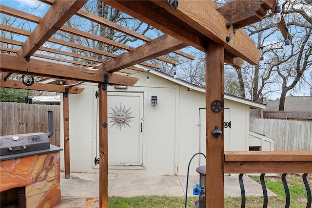 view of patio / terrace with a storage shed and a pergola