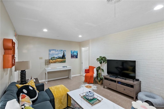 living area with recessed lighting, baseboards, and brick wall