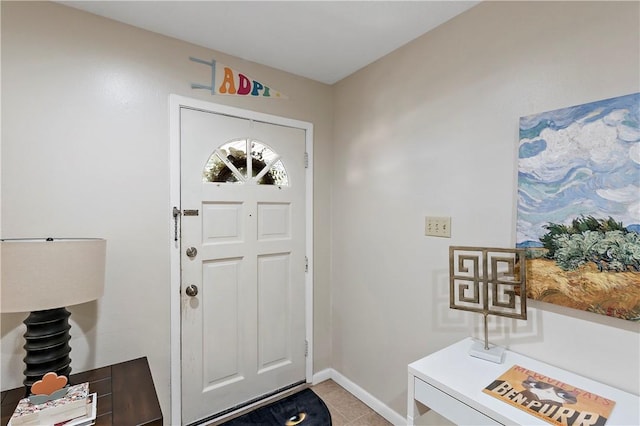 entryway featuring light tile patterned floors and baseboards