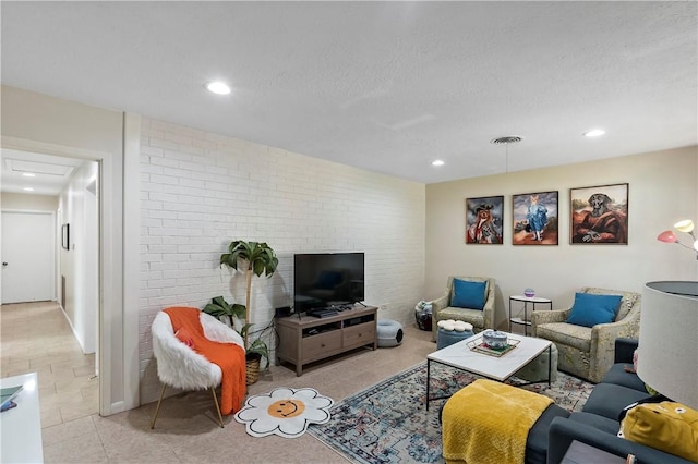 living area with visible vents, a textured ceiling, recessed lighting, brick wall, and light tile patterned floors