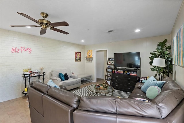 living area featuring recessed lighting, brick wall, and a ceiling fan