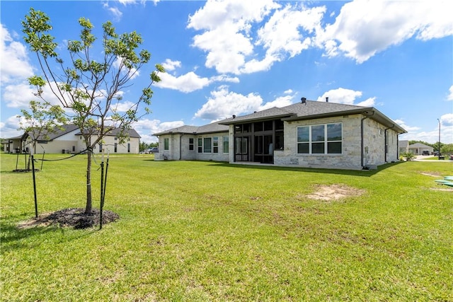 10724 Harvey Ranch Rd, College Station, TX 77845 - rear view of house with a yard, a sunroom, and stone siding