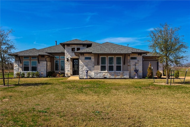 prairie-style house featuring an attached garage, a front yard, and fence