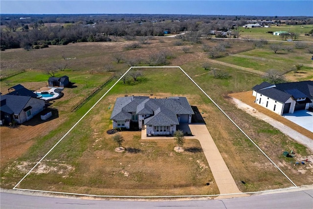 prairie-style house featuring an attached garage, a front yard, and fence